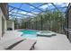 Inviting screened-in pool and spa area with cascading waterfall feature and plenty of room for lounge chairs at 418 Gleaming Andover Way, Longwood, FL 32779