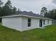Back exterior view of a newly built single story home with a white stucco exterior and dark roof at 4333 Sw 157Th Ter, Ocala, FL 34481