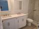Bright bathroom featuring double sinks, white cabinets, quartz counters, and a marble tiled shower at 4333 Sw 157Th Ter, Ocala, FL 34481
