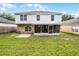 View of the home's backyard with well-maintained lawn and a screened patio at 4519 Willamette Cir, Orlando, FL 32826