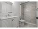 Clean white bathroom features a shower with gorgeous marbled tile and glass doors at 4519 Willamette Cir, Orlando, FL 32826