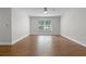 This bedroom features wood floors and a large window allowing for ample natural light at 4519 Willamette Cir, Orlando, FL 32826