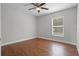 A bright bedroom features hard wood floors and a neutral color palette at 4519 Willamette Cir, Orlando, FL 32826
