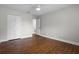 This bedroom is a clean slate with hardwood floors, a ceiling fan, and a bright white closet door at 4519 Willamette Cir, Orlando, FL 32826