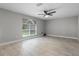 This bedroom features tile floors, a ceiling fan, and a large window allowing for ample natural light at 4519 Willamette Cir, Orlando, FL 32826
