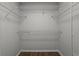The closet has white metal racks and wood flooring at 4519 Willamette Cir, Orlando, FL 32826