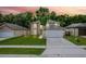 Two-story home features a well-manicured lawn, a two-car garage, and mature palm trees against a vibrant sunset backdrop at 4519 Willamette Cir, Orlando, FL 32826