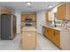Modern kitchen with stainless steel appliances, center island, tiled backsplash, and ample cabinet space at 4519 Willamette Cir, Orlando, FL 32826