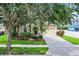 Charming single-Gathering home featuring a well-manicured lawn, two-car garage, and inviting front porch at 5063 Carillon Ln, Windermere, FL 34786