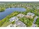Aerial view of houses in a lakeside neighborhood, boasting mature trees and well-maintained landscaping at 5063 Carillon Ln, Windermere, FL 34786