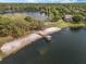 Aerial view of a lake featuring a gazebo over the water and a sandy beach area at 5063 Carillon Ln, Windermere, FL 34786