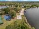 Aerial view featuring lake access with a volleyball court, basketball court and sandy beach at 5063 Carillon Ln, Windermere, FL 34786