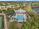 Aerial view of a community pool with lounge chairs and palm trees at 5063 Carillon Ln, Windermere, FL 34786