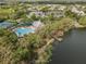 Aerial view showing the community pool and fishing pier along the lake's edge at 5063 Carillon Ln, Windermere, FL 34786