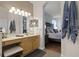 Well lit bathroom featuring a vanity with a bench and an arched doorway to the main bedroom at 5063 Carillon Ln, Windermere, FL 34786