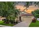 Charming single-Gathering home featuring a well-manicured lawn, two-car garage, and inviting front porch at 5063 Carillon Ln, Windermere, FL 34786