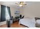 Bedroom featuring a ceiling fan, television, a large window and laminate wood flooring at 5063 Carillon Ln, Windermere, FL 34786