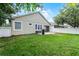 Fenced backyard featuring a patio with a grill and lots of grassy space at 5063 Carillon Ln, Windermere, FL 34786