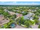 Aerial shot of a property in a peaceful, tree-filled neighborhood on a sunny day at 5063 Carillon Ln, Windermere, FL 34786