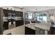 Modern kitchen featuring stainless steel appliances, granite countertops, and dark wood cabinets at 5063 Carillon Ln, Windermere, FL 34786