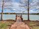 Lakeside dock offers a serene retreat, surrounded by calm waters and the tranquility of nature at 5063 Carillon Ln, Windermere, FL 34786