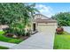 Charming single-Gathering home featuring a well-manicured lawn, two-car garage, and inviting front porch at 5063 Carillon Ln, Windermere, FL 34786