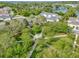 Aerial view of community with a gazebo on manicured grounds, mature trees, and well-maintained landscaping at 5063 Carillon Ln, Windermere, FL 34786