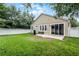 View of the private fenced backyard with green lawn, a patio, and lush landscaping at 5063 Carillon Ln, Windermere, FL 34786