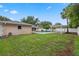 Spacious backyard featuring lush green grass, a sparkling pool, and a stylish gazebo for outdoor enjoyment at 5089 Jennifer Pl, Orlando, FL 32807