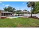 Backyard view featuring a pool, a white fence, and a gazebo perfect for summer gatherings at 5089 Jennifer Pl, Orlando, FL 32807