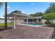 Backyard view featuring a sparkling pool, a covered gazebo, and a brick patio, perfect for outdoor entertaining at 5089 Jennifer Pl, Orlando, FL 32807