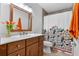 Bathroom featuring a floral shower curtain, wood vanity, and flower decoration at 5089 Jennifer Pl, Orlando, FL 32807