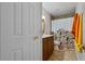 Bathroom featuring a patterned shower curtain and vanity area with dark brown cabinetry at 5089 Jennifer Pl, Orlando, FL 32807