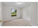 Bedroom with a large window providing ample natural light and front yard view at 5089 Jennifer Pl, Orlando, FL 32807