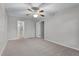This carpeted bedroom has a ceiling fan and easy access to the bathroom and closet at 5089 Jennifer Pl, Orlando, FL 32807