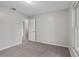 Clean bedroom with neutral colored carpet and adjacent room off to the left at 5089 Jennifer Pl, Orlando, FL 32807