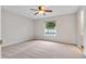 Bedroom showcasing a window view with a ceiling fan and neutral color palette at 5089 Jennifer Pl, Orlando, FL 32807