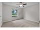 Bright bedroom featuring a ceiling fan and a large window overlooking the front yard at 5089 Jennifer Pl, Orlando, FL 32807