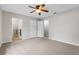 Bedroom featuring a double door entrance, carpeted floors and a ceiling fan at 5089 Jennifer Pl, Orlando, FL 32807