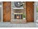 Cozy room showcasing a brick fireplace with wood paneling and tiled flooring creating an inviting atmosphere at 5089 Jennifer Pl, Orlando, FL 32807