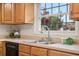 Well-appointed kitchen featuring a stainless steel sink and a large window offering a garden view at 5089 Jennifer Pl, Orlando, FL 32807
