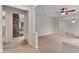 Open-concept living area with neutral carpet and paint, enhanced by stylish architectural details at 5089 Jennifer Pl, Orlando, FL 32807