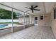 Enclosed patio with tile flooring, fan, and view of the pool area offers a relaxing outdoor living space at 5089 Jennifer Pl, Orlando, FL 32807