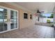 Screened patio featuring tiled flooring and a ceiling fan for warm summer days at 5089 Jennifer Pl, Orlando, FL 32807