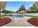 Private swimming pool and shaded cabana create a serene backyard escape for relaxation and entertaining at 5089 Jennifer Pl, Orlando, FL 32807