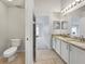 Bright bathroom featuring a double sink vanity with granite countertops and tiled floors at 5231 Alavista Dr, Orlando, FL 32837