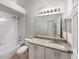 Bathroom vanity with granite countertops and white cabinets, featuring a shower and tub at 5231 Alavista Dr, Orlando, FL 32837