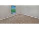 A carpeted bedroom is shown with a window looking out onto a green lawn at 5231 Alavista Dr, Orlando, FL 32837