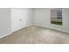 Bedroom with carpeted floors and neutral walls featuring a closet with sliding doors at 5231 Alavista Dr, Orlando, FL 32837