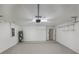 Well-lit garage featuring an electric water heater, clean floors, and overhead lighting at 5231 Alavista Dr, Orlando, FL 32837